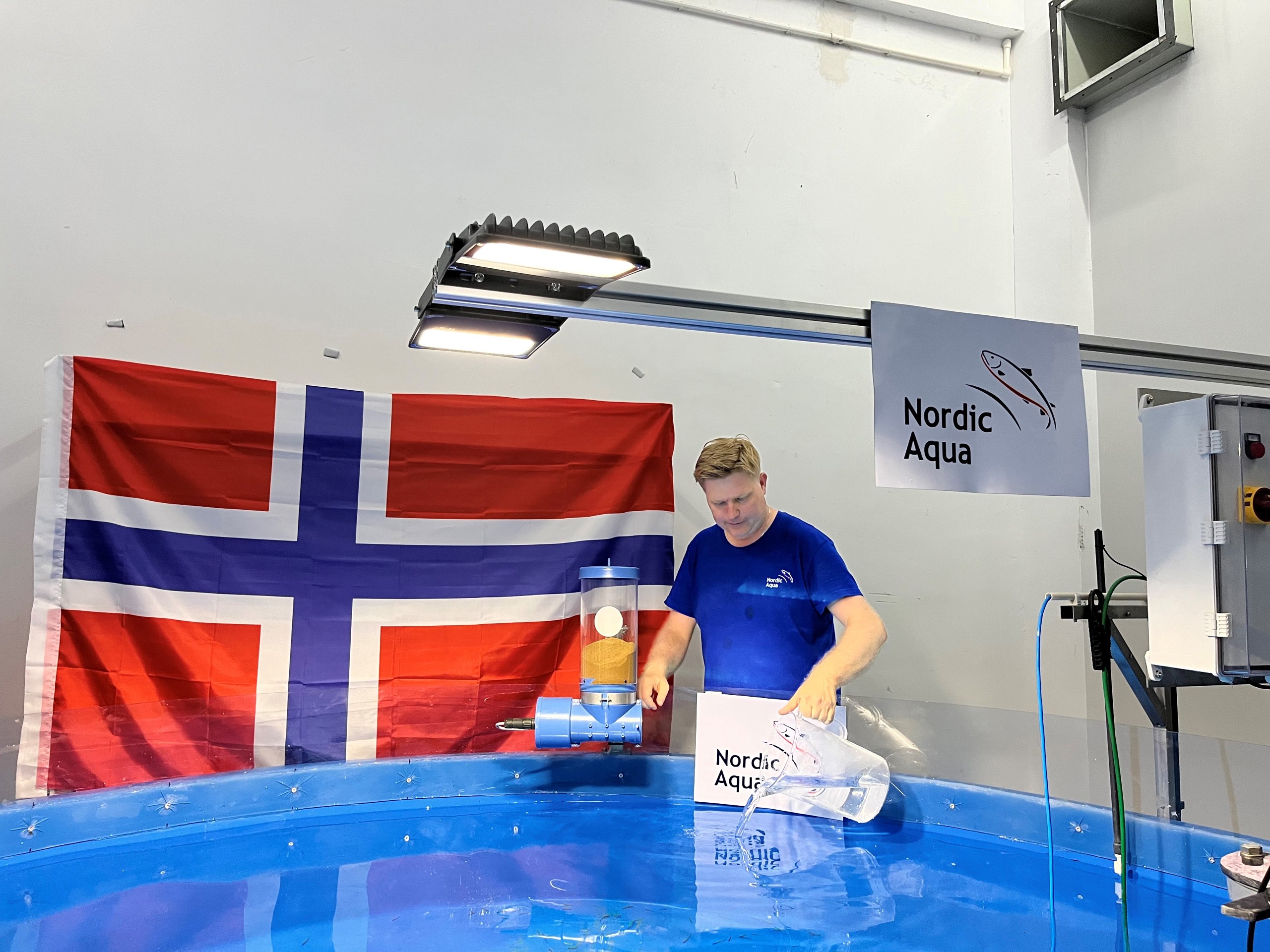 Farm Manager, Ola transferring the first fish to start feeding